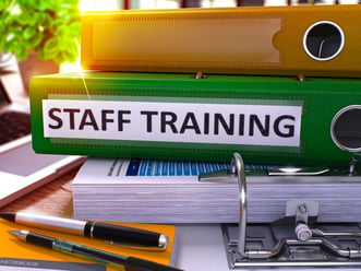 Staff Training - Green Office Folder on Background of Working Table with Stationery and Laptop. Staff Training Business Concept on Blurred Background. Staff Training Toned Image. 3D.-1