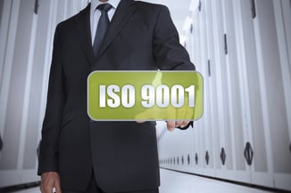 Businessman in a data center selecting a green label with iso 9001 written on it-1