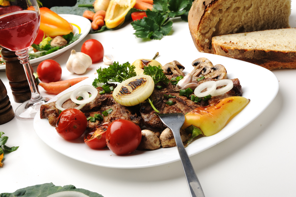 Delicious prepared and decorated food on table in restaurant