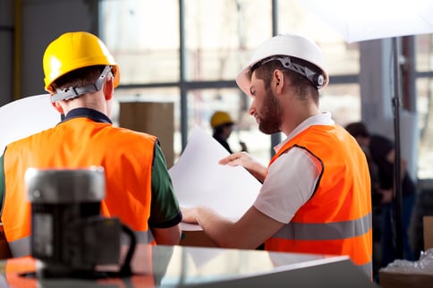 Male factory worker and supervisor are analyzing plans-4