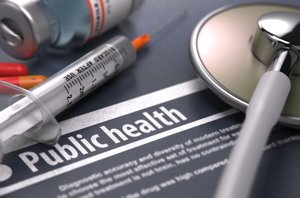 Public Health. Medical Concept with Blurred Text, Stethoscope, Pills and Syringe on Grey Background. Selective Focus.